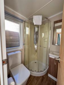 a bathroom with a shower and a toilet and a sink at UCamp Kemmelberg in Heuvelland