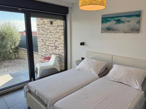 a bedroom with a bed and a large window at Villa Nina in Šmrika +44 photos