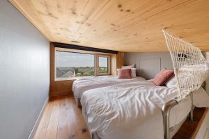 two beds in a room with a large window at La villa Grand Ouest in Plounéour-Trez +35 photos