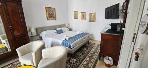 a small bedroom with a bed and a chair at Al Corso Charming Rooms in Peschici