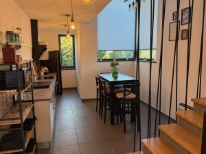 a kitchen with a table and chairs in a room at Villa Nina in Šmrika