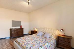 a bedroom with a bed and two night stands at La Matrice in Garlenda