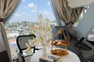 a room with a table with a view of a city at TTR Skypool View Hotel - Đà lạt in Da Lat