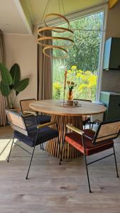 a dining room with a table and chairs at Tiny House De Klyster in Westergeest +12 photos
