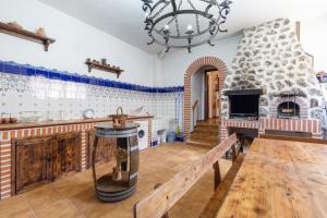 a large room with a stone fireplace and a table at La Casona de Sacramenia in Sacramenia
