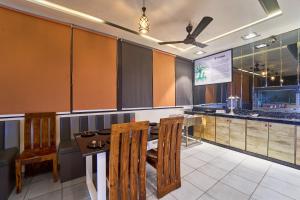 a restaurant with a table and chairs and a counter at Treebo Park View Villa in Jodhpur +38 photos