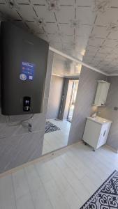 a room with a wall with a sign on it at Koch Iz guest house in Kochkorka +5 photos