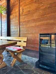 a wooden bench sitting in front of a wooden wall at Cabana 84 in Beclean
