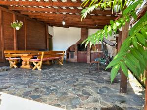 a patio with a wooden table and a bench at Cabana 84 in Beclean