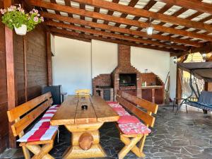 a wooden table and benches in a room with a fireplace at Cabana 84 in Beclean