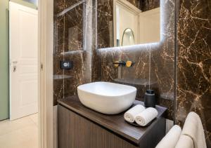 a bathroom with a white sink and a mirror at B and G San Babila- Luxury in the heart of Milano - Design district in Milan +40 photos