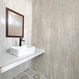 a bathroom with a sink and a mirror at Canggu Rice Field Villa 8B in Dalung +13 photos
