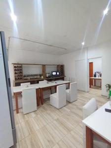 a white room with a table and white chairs at Hotel Maipú in Maipú