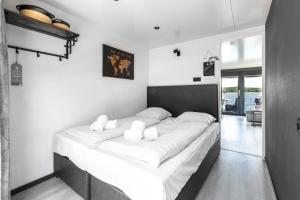 a bedroom with a large bed with white sheets at Houseboat Marina Mookerplas on the Water | 4 - 6 people in Middelaar