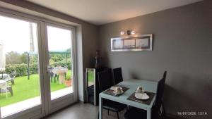 a dining room with a table and a window at Vilar Norte in Bueu
