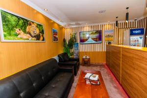 a waiting room with a couch and a table at The Royal Residence in Kitengela 