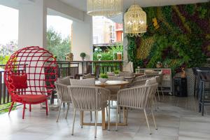a restaurant with a table and chairs and a green wall at Hotel Central in Sunny Beach