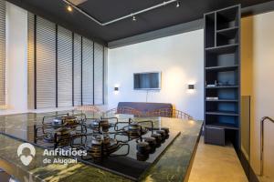 a dining room with a table with a stove at Cobertura Duplex Vista Cidade Centro TV4061 in Blumenau