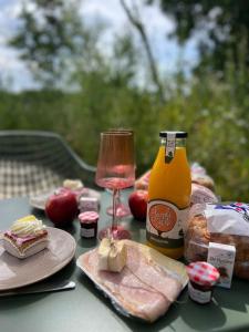 a table with food and a bottle of mustard and bread at Tiny house De Wylp in Westergeest
