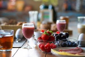 a table with two glasses of wine and fruit at Erve 't Hacht in Ane +23 photos