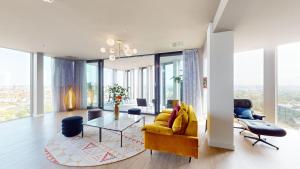 a living room with a yellow couch and a glass table at nhow Amsterdam Rai in Amsterdam