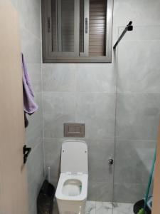 a small bathroom with a toilet and a window at Apprtmnt jury de luxe 6 in Nador +33 photos