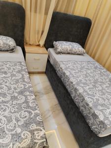 two beds sitting next to each other in a room at Apprtmnt jury de luxe 6 in Nador