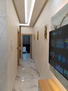 a hallway in a building with a tv on the wall at Apprtmnt jury de luxe 6 in Nador