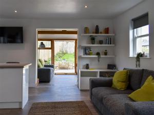 a living room with two couches and a door to a patio at Little Plumtree in Addingham +9 photos