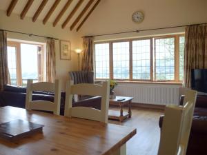 a living room with a table and chairs at Talog Barn-Uk31366 in Tregynon