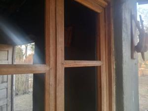 a glass door with a wooden window in a room at Mabuu Drive Inn in Waya