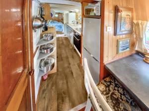 a small kitchen with a refrigerator and a table at The Prince - Uk42204 in Clachan of Glendaruel +20 photos
