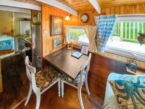 a dining room in a tiny house with a table and chairs at The Prince - Uk42204 in Clachan of Glendaruel