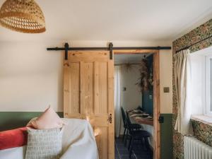 a room with a wooden door and a table at The Green One On The End in Thurton