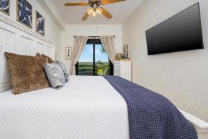 a bedroom with a bed and a flat screen tv at Phoenix VII 7015 condo in Orange Beach +39 photos
