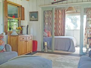 a bedroom with a bed and a large window at Willow's Rest in Crafthole