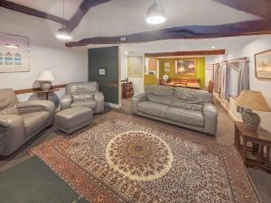 a living room with couches and a rug at Little Knott in High Nibthwaite
