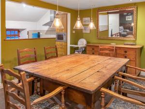 a dining room with a wooden table and chairs at Little Knott in High Nibthwaite +17 photos