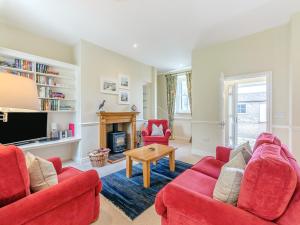 a living room with two red couches and a fireplace at Wellwood - Uk49290 in Preston