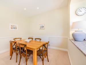 a dining room with a wooden table and chairs at Wellwood - Uk49290 in Preston