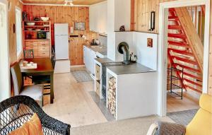 a kitchen with a white refrigerator and a table at Stunning Home In Seim With Wifi in Seim