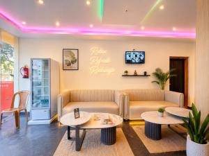 a waiting room with two tables and a couch at Hotel Pushparaj Puri - Beach front Hotel near Light House - Sea Facing AC Rooms - with Restaurant, Parking Facilities in Puri +15 photos