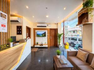 a living room with a couch and a table at Hotel Pushparaj Puri - Beach front Hotel near Light House - Sea Facing AC Rooms - with Restaurant, Parking Facilities in Puri