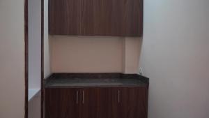 a small closet with a wooden cabinet in a room at Surf House Dakhla in Dakhla