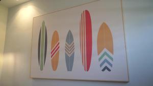 a framed picture of surfboards on a wall at Surf House Dakhla in Dakhla