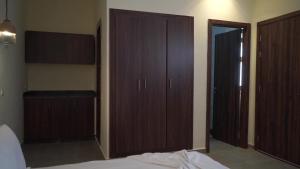 a bedroom with wooden closets and a bed at Surf House Dakhla in Dakhla