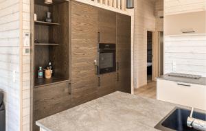 a kitchen with wood paneling and a counter top at 3 Bedroom Beautiful Home In Fjerritslev in Fjerritslev
