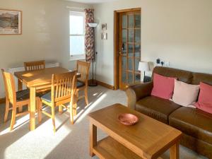 a living room with a couch and a table at 1 Lonsdale House in Keswick