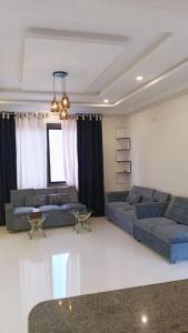 a living room with two couches and a table at Dreamer Guest house in Nathia Gali