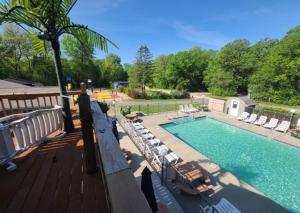 a view of a swimming pool with chaise lounge chairs at Baraboo RV Resort in Baraboo